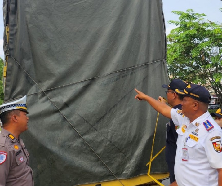 Petugas gabungan mengukur ketinggian bak truk barang saat razia di Jalan SM Amin. Foto: Istimewa.