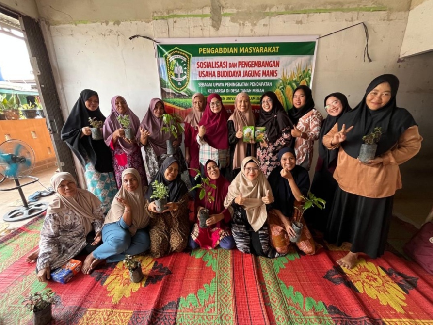 Dosen Universitas Islam Riau saat menyerahkan bibit jagung manis kepada warga Desa Tanah Merah, Kecamatan Siak Hulu, Kabupaten Kampar dalam kegiatan Pengabdian Masyarakat, Sabtu (4/4/2026).